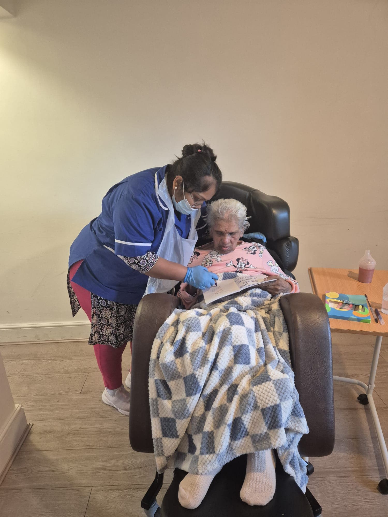 Carer supporting a resident with an engaging activity
